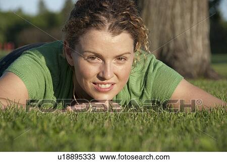 Head shot of woman on grass in parke, Winnipeg, Canada View Large Photo Image Stock Image - Head shot of woman on grass in parke, Winnipeg, Canada. Fotosearch