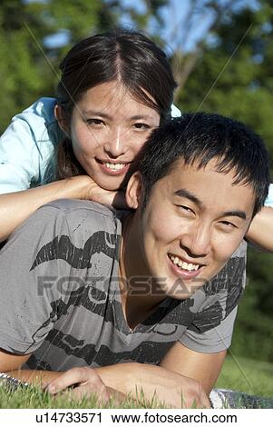Headshot of young couple lying on grass, Assiniboine Park, Winnipeg, Canada View Large Photo Image Stock Image - Headshot of young couple lying on grass, Assiniboine Park, Winnipeg, Canada. Fotosearch
