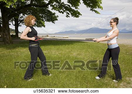 Instructor and woman practicing yoga on beach, Vancouver, BC View Large Photo Image Stock Image - Instructor and woman practicing yoga on beach, Vancouver, BC. Fotosearch