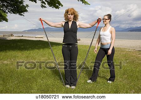 Instructor and woman practicing yoga on beach, Vancouver, BC View Large Photo Image Stock Image - Instructor and woman practicing yoga on beach, Vancouver, BC. Fotosearch