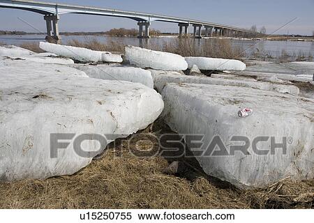 Stock Photography - Large chunks of ice on banks of Red River, Manitoba. Fotosearch