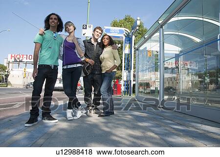 Lower angle shot, group of teens waiting at transit shelter, Winnipeg, Manitoba, Canada View Large Photo Image Stock Photo - Lower angle shot, group of teens waiting at transit shelter, Winnipeg, Manitoba, Canada. Fotosearch