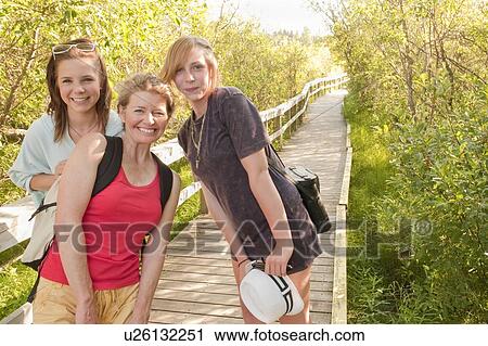 Mid-aged woman and two teen girls on nature boardwalk; Riding Mountain National Park; Clear Lake, Manitoba, Canada View Large Photo Image Stock Image - Mid-aged woman and two teen girls on nature boardwalk; Riding Mountain National Park; Clear Lake, Manitoba, Canada. Fotosearch