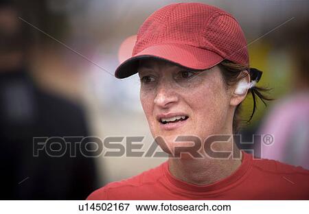 Stock Photo - Middle aged female runner with cotton in her ears after race, Regina, Saskatchewan. Fotosearch