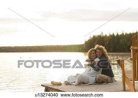 Mom and adult daughter on dock at Clear Lake, Manitoba, Canada View Large Photo Image Stock Image - Mom and adult daughter on dock at Clear Lake, Manitoba, Canada. Fotosearch