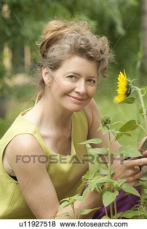 Portrait of woman in garden, Manitoba, Canada View Large Photo Image Stock Photo - Portrait of woman in garden, Manitoba, Canada. Fotosearch