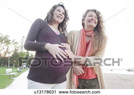 Pregnant woman and friend on beach boardwalk, Clear Lake, Manitoba, Canada View Large Photo Image Stock Image - Pregnant woman and friend on beach boardwalk, Clear Lake, Manitoba, Canada. Fotosearch