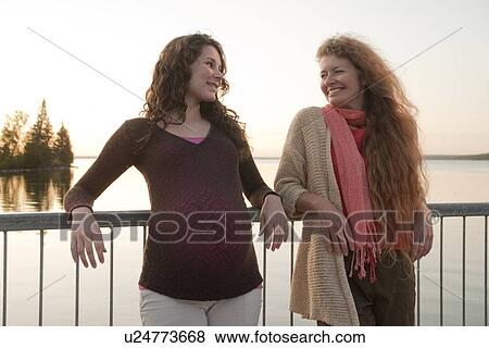 Pregnant woman and friend, sunset, Clear Lake, Manitoba, Canada View Large Photo Image Stock Photo - Pregnant woman and friend, sunset, Clear Lake, Manitoba, Canada. Fotosearch