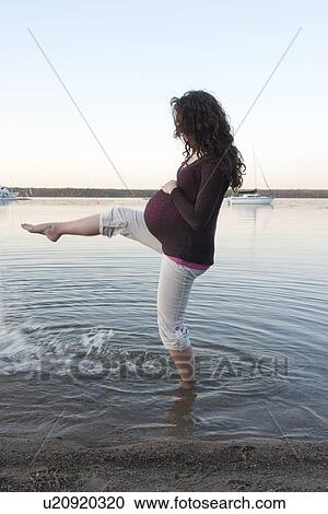 Pregnant woman kicking in shallow water, Clear Lake, Manitoba, Canada View Large Photo Image Stock Image - Pregnant woman kicking in shallow water, Clear Lake, Manitoba, Canada. Fotosearch