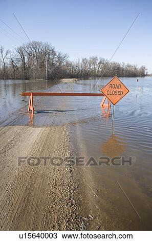 Stock Image - Road is closed due to Red River flooding in rural Manitoba. Fotosearch