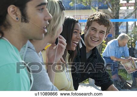 Stock Photograph - Row of teen faces at transit shelter, Winnipeg, Manitoba, Canada. Fotosearch