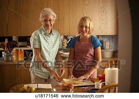 Senior woman and her twelve year old great granddaughter in kitchen; Redvers, Saskatchewan, Canada View Large Photo Image Stock Photograph - Senior woman and her twelve year old great granddaughter in kitchen; Redvers, Saskatchewan, Canada. Fotosearch