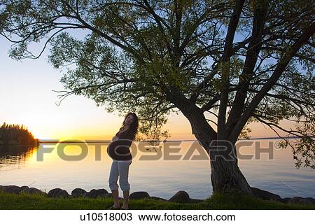 Silohuette of pregnant woman at sunset, Clear Lake, Manitoba, Canada View Large Photo Image Stock Image - Silohuette of pregnant woman at sunset, Clear Lake, Manitoba, Canada. Fotosearch