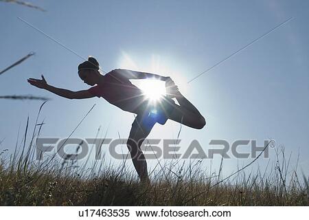Silohuette of woman stretching, sun flare, Manitoba, Canada View Large Photo Image Stock Photography - Silohuette of woman stretching, sun flare, Manitoba, Canada. Fotosearch