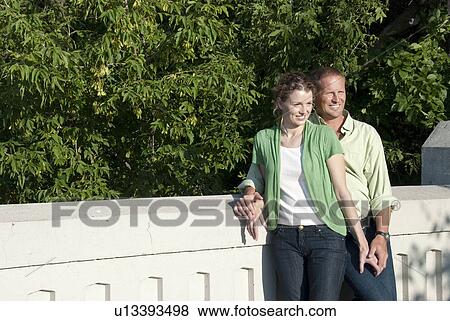 Smiling couple standing on bridge, Assiniboine Park, Winnipeg, Canada View Large Photo Image Stock Photo - Smiling couple standing on bridge, Assiniboine Park, Winnipeg, Canada. Fotosearch
