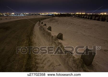 Stock Photo - Snowy road outside Regina, Saskatchewan, just before dawn.. Fotosearch