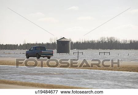 Spring floodwater of Red River come close to covering highway View Large Photo Image Stock Photo - Spring floodwater of Red River come close to covering highway. Fotosearch