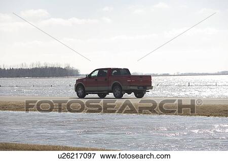 Spring floodwater of Red River come close to covering highway View Large Photo Image Stock Photo - Spring floodwater of Red River come close to covering highway. Fotosearch