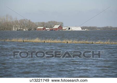 Spring floodwaters of the Red River make an island of a framyard, rural Manitoba View Large Photo Image Stock Photo - Spring floodwaters of the Red River make an island of a framyard, rural Manitoba. Fotosearch