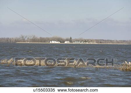 Spring floodwaters of the Red River make an island of a framyard, rural Manitoba View Large Photo Image Stock Photography - Spring floodwaters of the Red River make an island of a framyard, rural Manitoba. Fotosearch