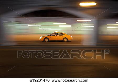 Stock Image - Taxicab southbound on Lower Simcoe Street underpass near Union Station, Toronto. Fotosearch