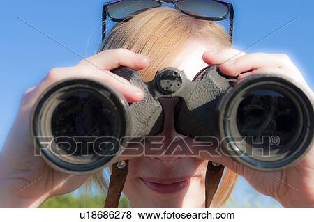 Teen girl looking through binoculars toward camera, Riding Mountain National Park, Manitoba, Canada View Large Photo Image Stock Photo - Teen girl looking through binoculars toward camera, Riding Mountain National Park, Manitoba, Canada. Fotosearch