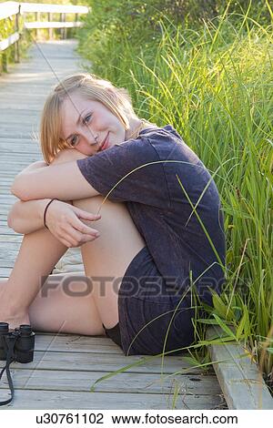 Teen seated on boardwalk in marsh, Riding Mountain National Park, Manitoba, Canada View Large Photo Image Stock Image - Teen seated on boardwalk in marsh, Riding Mountain National Park, Manitoba, Canada. Fotosearch