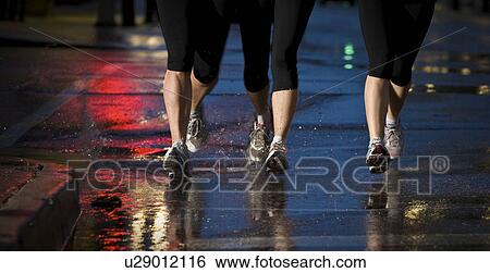 Three pair of runners' feet on wet pavement, Regina, Saskatchewan View Large Photo Image Stock Photograph - Three pair of runners' feet on wet pavement, Regina, Saskatchewan. Fotosearch