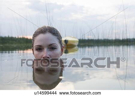 Top portion of young woman's head above the water, Lake Katherine, Riding Mountain National Park, Manitoba, Canada View Large Photo Image Picture - Top portion of young woman's head above the water, Lake Katherine, Riding Mountain National Park, Manitoba, Canada. Fotosearch