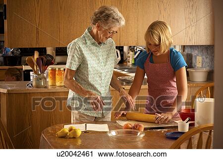 Twelve-year old girl rolling pastry beside her great grandmother; Redvers, Saskatchewan, Canada View Large Photo Image Stock Image - Twelve-year old girl rolling pastry beside her great grandmother; Redvers, Saskatchewan, Canada. Fotosearch