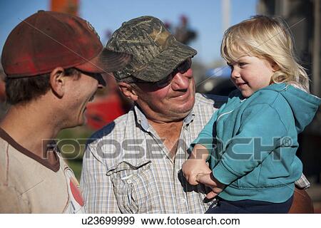 Stock Photo - Two farmers and young girl, Redvers, Saskatchewan, Canada. Fotosearch