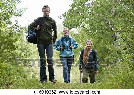 Two girls and woman out hiking in poplar grove, Manitoba, Canada View Large Photo Image Stock Image - Two girls and woman out hiking in poplar grove, Manitoba, Canada. Fotosearch