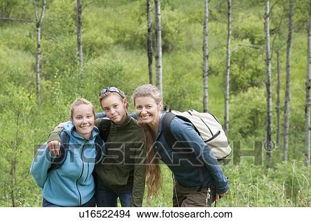 Picture - Two girls and woman posed on hiking trail, Manitoba, Canada. Fotosearch