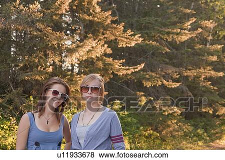 Stock Photo - Two teen girls outddor, Riding Mountain National Park, Manitoba, Canada. Fotosearch