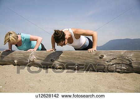 Two women doing push-ups on log at beach, Vancouver, BC View Large Photo Image Stock Image - Two women doing push-ups on log at beach, Vancouver, BC. Fotosearch