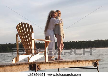 Two women embrace on dock, Clear Lake, Manitoba, Canada View Large Photo Image Stock Image - Two women embrace on dock, Clear Lake, Manitoba, Canada. Fotosearch