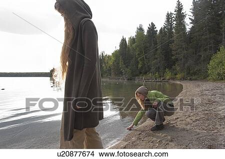 Picture - Two women on shoreline of Clear Lake, Riding Mountain National Park, Manitoba, Canada. Fotosearch