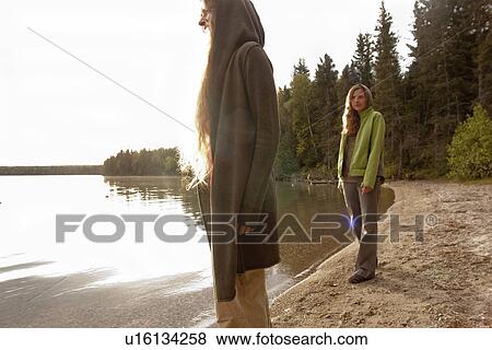 Stock Photo - Two women on shoreline of Clear Lake, Riding Mountain National Park, Manitoba, Canada. Fotosearch