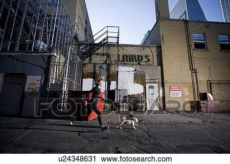Woman and dog running at rear of downtown buildings, Regina, Saskatchewan View Large Photo Image Stock Image - Woman and dog running at rear of downtown buildings, Regina, Saskatchewan. Fotosearch