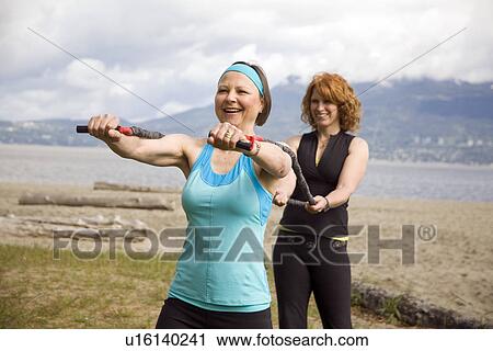 Woman and instructor using yoga bands on beach, Vancouver, BC View Large Photo Image Stock Image - Woman and instructor using yoga bands on beach, Vancouver, BC. Fotosearch