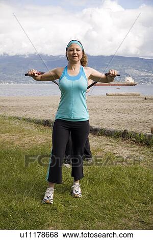 Woman and instructor using yoga bands on beach, Vancouver, BC View Large Photo Image Stock Photo - Woman and instructor using yoga bands on beach, Vancouver, BC. Fotosearch