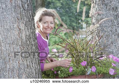 Woman beside large flower pot, Manitoba, Canada View Large Photo Image Stock Photography - Woman beside large flower pot, Manitoba, Canada. Fotosearch