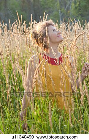 Woman holding basket stands in tall grass, Manitoba, Canada View Large Photo Image Stock Image - Woman holding basket stands in tall grass, Manitoba, Canada. Fotosearch