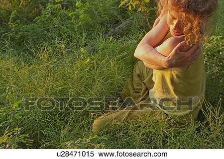 Woman hugging herself seated outdoors, Clear Lake, Manitoba, Canada View Large Photo Image Stock Photography - Woman hugging herself seated outdoors, Clear Lake, Manitoba, Canada. Fotosearch