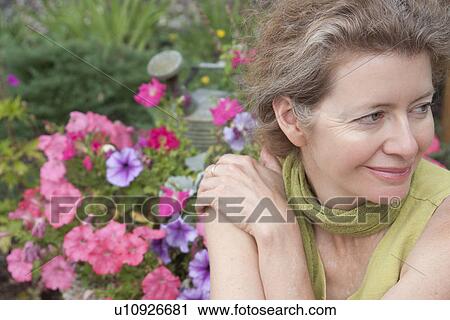 Woman in front of flower garden, Manitoba, Canada View Large Photo Image Stock Image - Woman in front of flower garden, Manitoba, Canada. Fotosearch