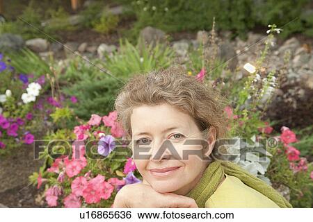 Woman in front of flower garden, Manitoba, Canada View Large Photo Image Stock Photograph - Woman in front of flower garden, Manitoba, Canada. Fotosearch