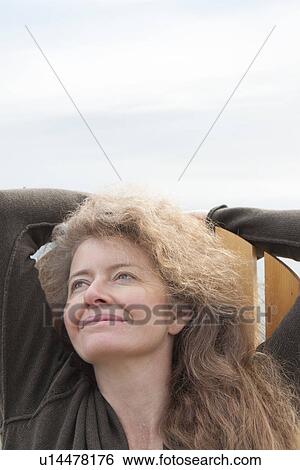 Stock Photograph - Woman looking upward beside Clear Lake, Manitoba, Canada. Fotosearch
