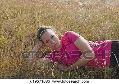 Woman propped up on her elbow on hillside, Manitoba, Canada View Large Photo Image Stock Photography - Woman propped up on her elbow on hillside, Manitoba, Canada. Fotosearch