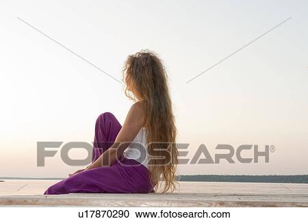Woman seated on dock by Clear Lake, Manitoba, Canada View Large Photo Image Stock Image - Woman seated on dock by Clear Lake, Manitoba, Canada. Fotosearch
