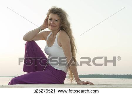 Woman seated on dock by Clear Lake, Manitoba, Canada View Large Photo Image Stock Image - Woman seated on dock by Clear Lake, Manitoba, Canada. Fotosearch